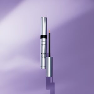 A purple background with a silver tube of liquid and a black bottle.