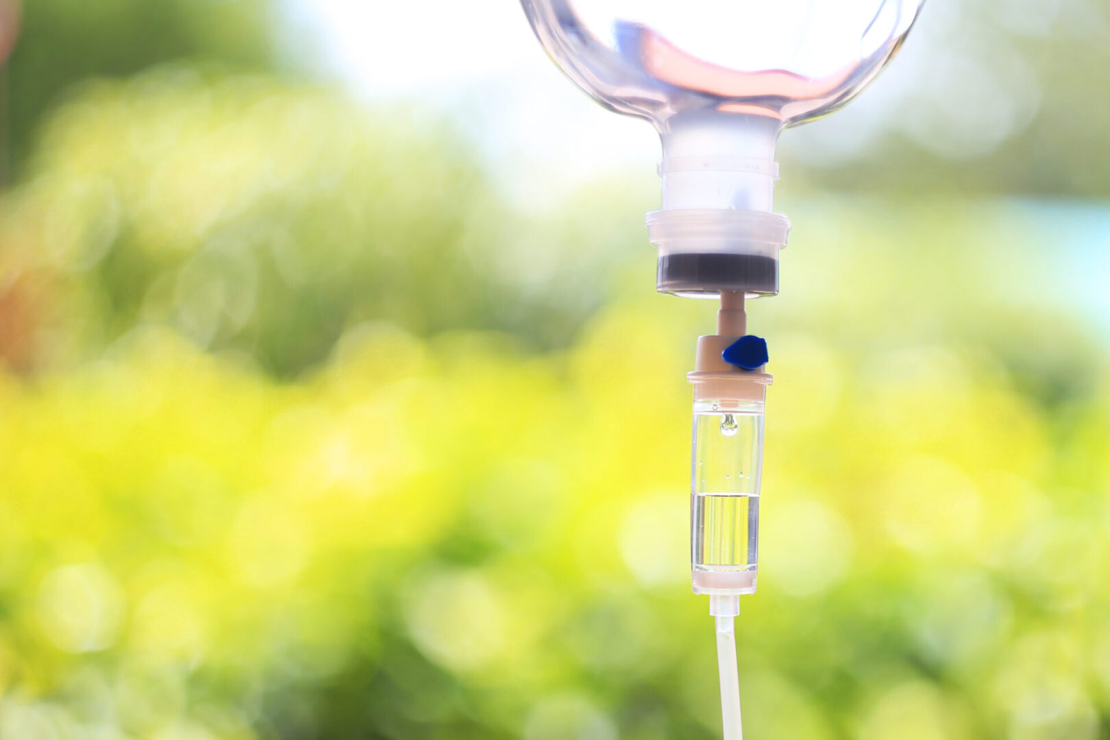 A close up of an empty syringe with a green background